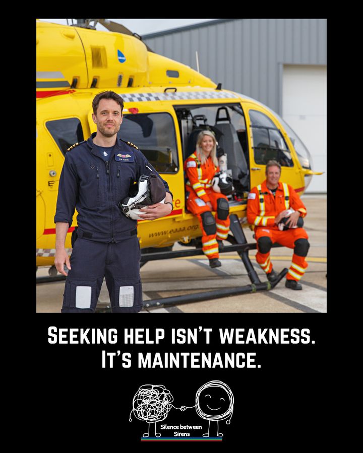 Air ambulance crew beside their helicopter with the words Seeking help isn't weakness. It's maintenance.